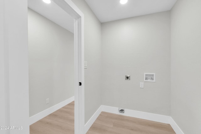 washroom featuring electric dryer hookup, washer hookup, and light wood-type flooring