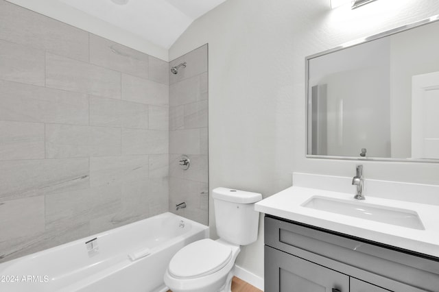 full bathroom featuring tiled shower / bath combo, toilet, lofted ceiling, and vanity