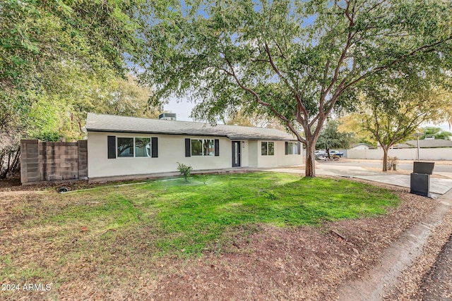 ranch-style house with a front lawn