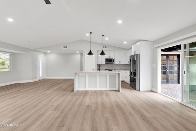 kitchen featuring appliances with stainless steel finishes, light wood-type flooring, white cabinetry, and pendant lighting