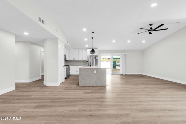 unfurnished living room with ceiling fan, light hardwood / wood-style floors, sink, and vaulted ceiling