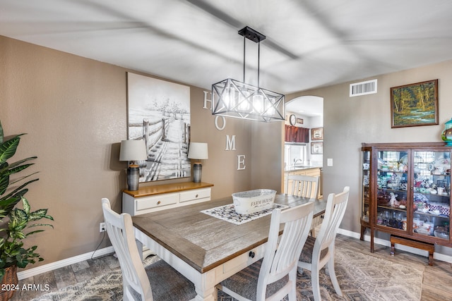 dining room featuring hardwood / wood-style floors and sink