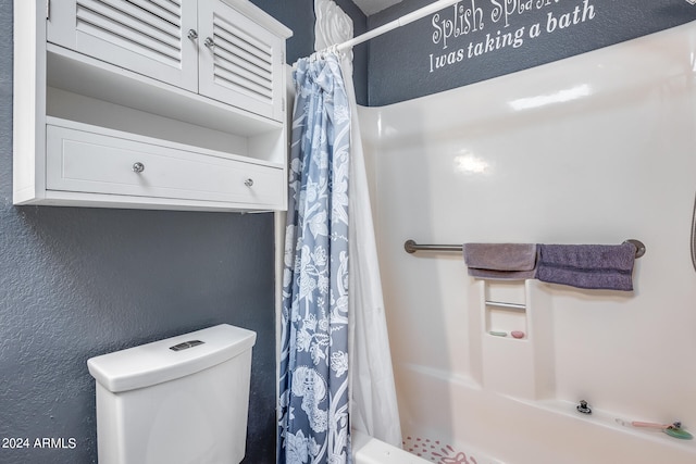 bathroom featuring toilet and shower / bath combination with curtain