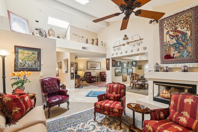 living room with ceiling fan, high vaulted ceiling, and beamed ceiling