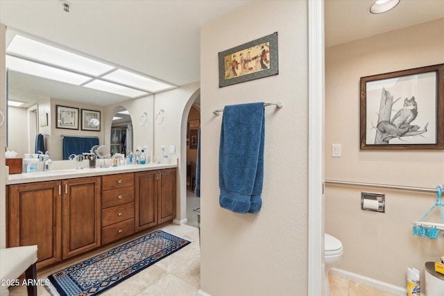 bathroom with vanity, tile patterned floors, and toilet