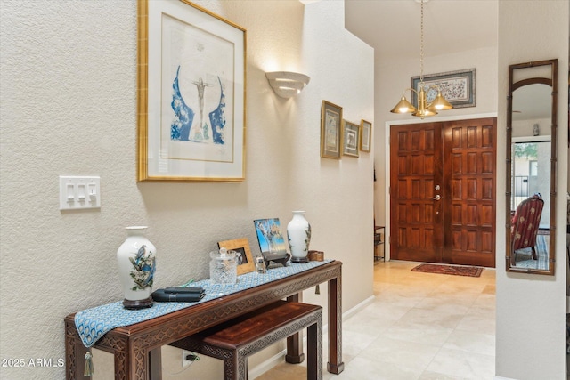 entryway with a chandelier