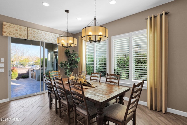 dining area featuring hardwood / wood-style flooring and an inviting chandelier