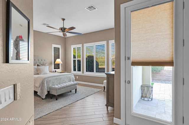 bedroom with ceiling fan and light hardwood / wood-style floors