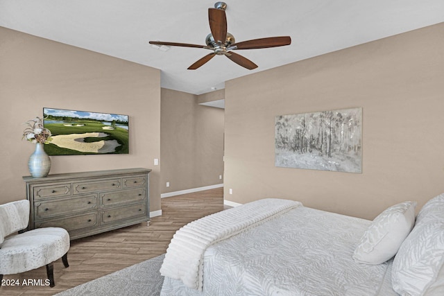 bedroom with ceiling fan and light hardwood / wood-style flooring