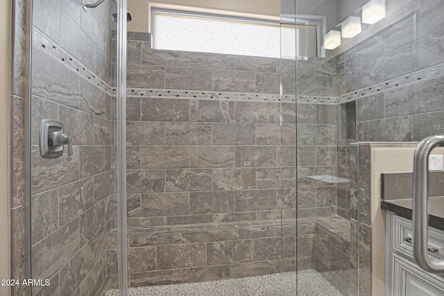 bathroom with a shower with door