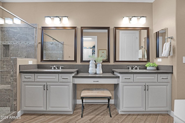 bathroom featuring vanity, hardwood / wood-style flooring, and walk in shower