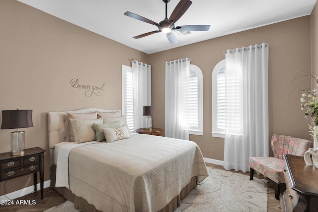 bedroom with ceiling fan and light wood-type flooring