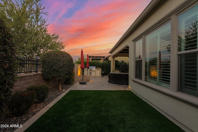 yard at dusk with a patio