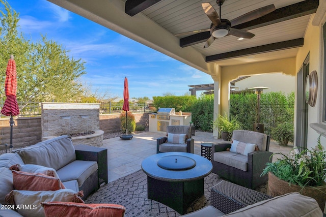 view of patio featuring grilling area, an outdoor living space, ceiling fan, and exterior kitchen