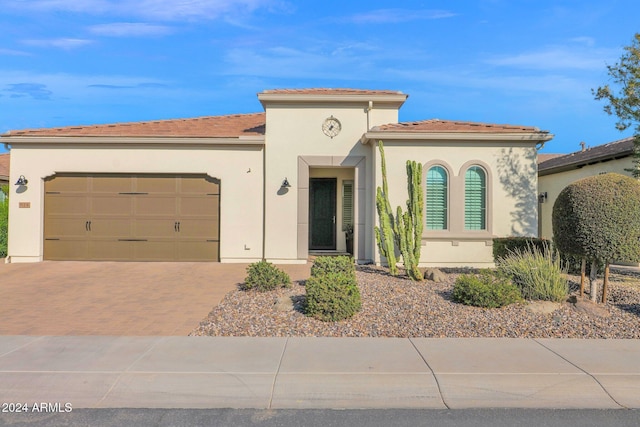 mediterranean / spanish-style house with a garage