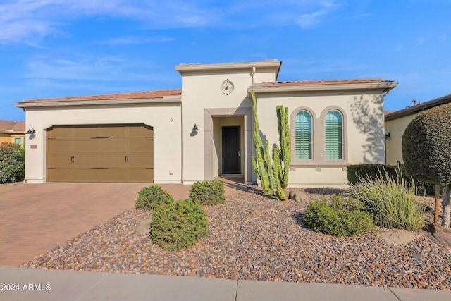 mediterranean / spanish-style house with a garage