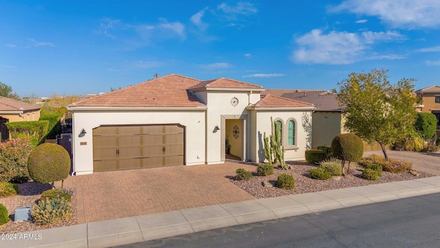 mediterranean / spanish-style home with a garage