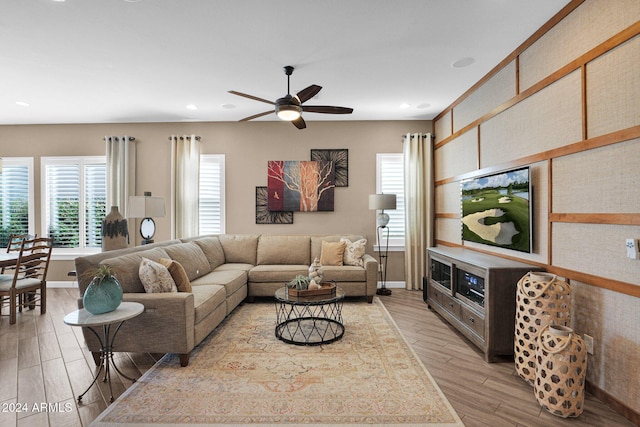 living room featuring light wood-type flooring and ceiling fan