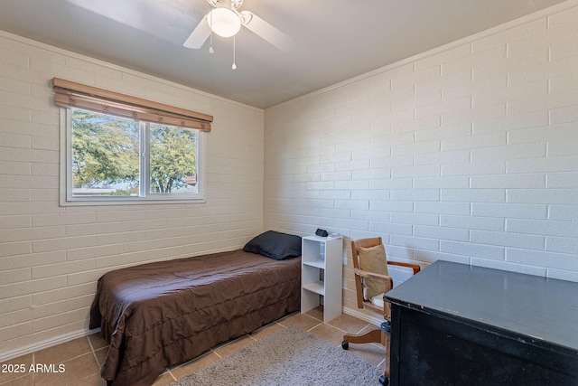 bedroom with brick wall, light tile patterned floors, and ceiling fan