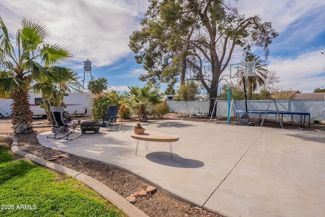 view of patio / terrace with an outdoor fire pit and a trampoline