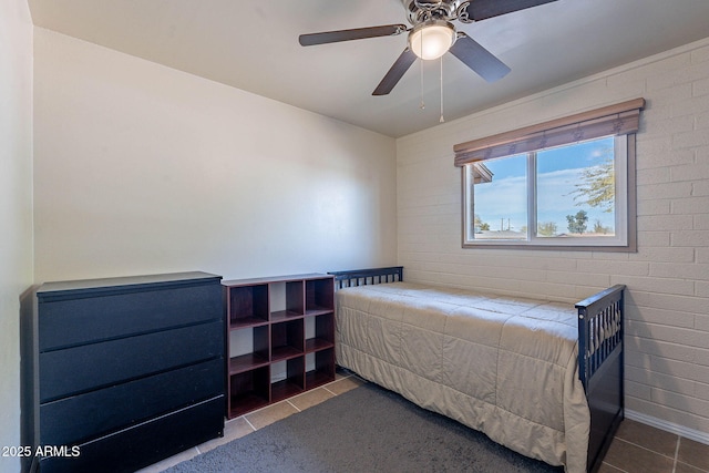 tiled bedroom featuring ceiling fan