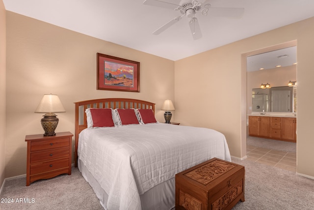 bedroom with ensuite bathroom, ceiling fan, and light carpet