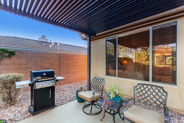 view of patio with area for grilling and a pergola