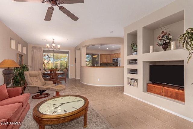 living room with ceiling fan with notable chandelier and light tile patterned floors