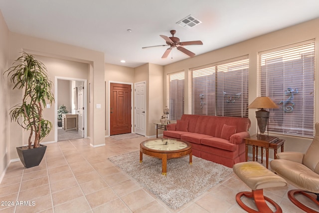 tiled living room featuring ceiling fan