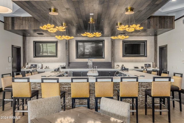 interior space featuring wood ceiling, decorative light fixtures, and light hardwood / wood-style floors