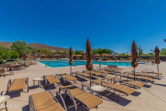 view of pool featuring a mountain view and a patio