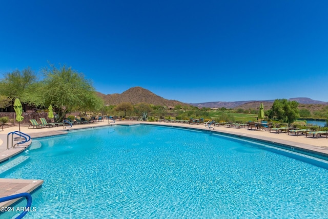 view of pool with a patio area and a mountain view