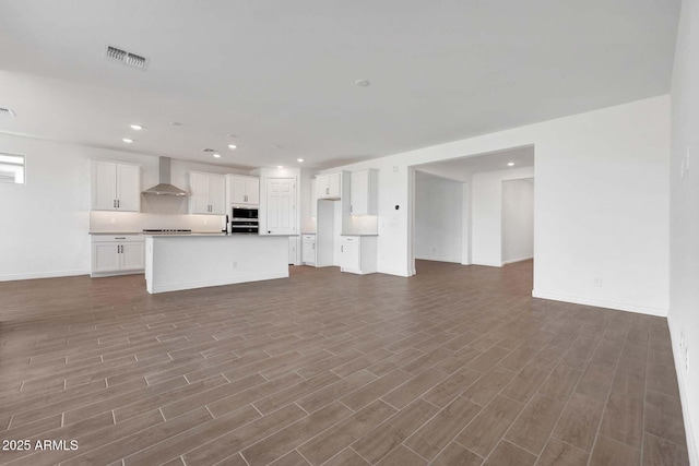 unfurnished living room featuring hardwood / wood-style floors