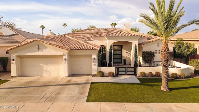 mediterranean / spanish-style house featuring a garage and a front yard