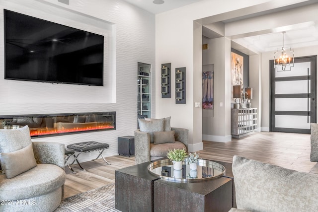 living room with wood-type flooring and a notable chandelier