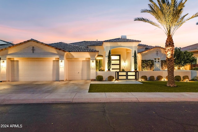 mediterranean / spanish-style house with a garage