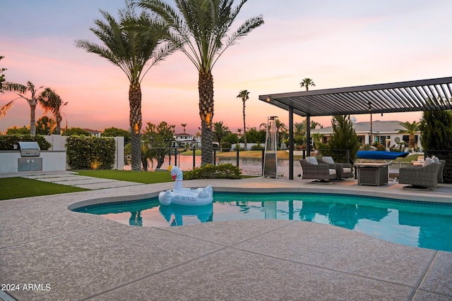 pool at dusk with area for grilling, an outdoor hangout area, a patio area, and a grill