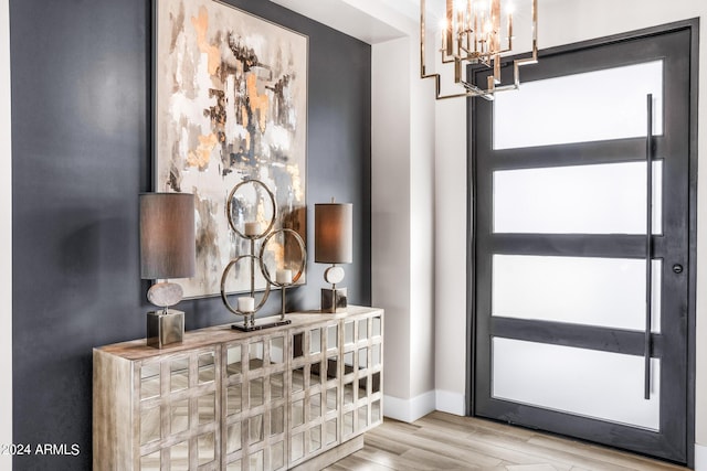 entryway featuring an inviting chandelier and light hardwood / wood-style floors