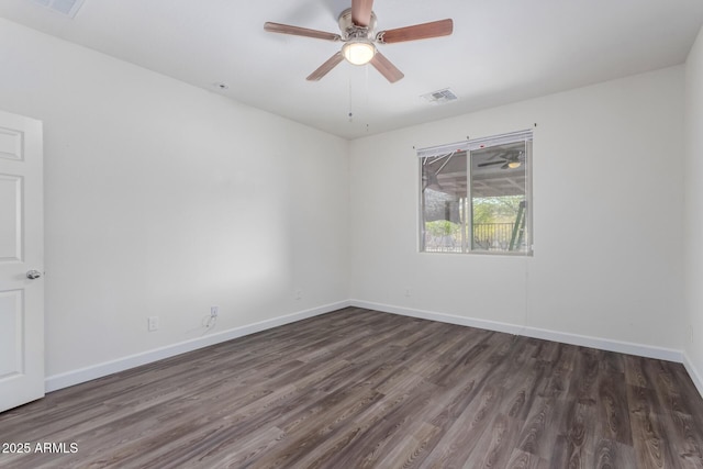 spare room with dark wood-type flooring and ceiling fan