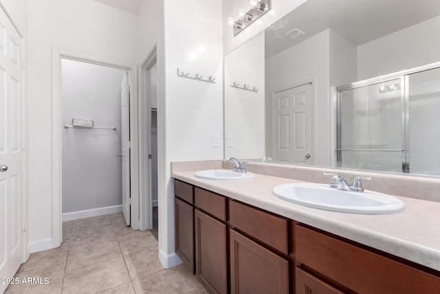 bathroom featuring vanity, tile patterned floors, and walk in shower