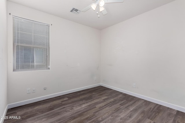 spare room featuring dark hardwood / wood-style floors and ceiling fan