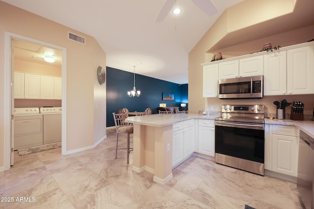 kitchen with white cabinetry, hanging light fixtures, independent washer and dryer, kitchen peninsula, and stainless steel appliances