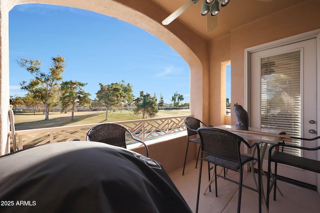 view of patio / terrace with ceiling fan and a balcony