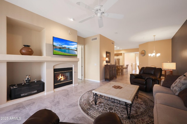 living room with ceiling fan with notable chandelier