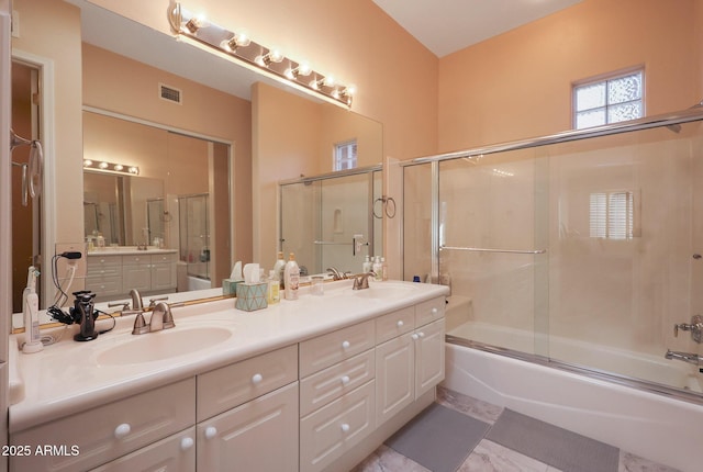 bathroom with vanity and combined bath / shower with glass door