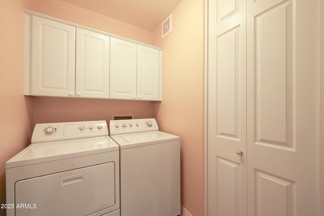 laundry room featuring independent washer and dryer and cabinets