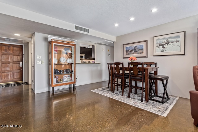 dining room featuring a textured ceiling