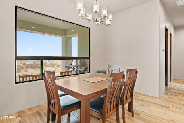 dining area featuring an inviting chandelier and light wood-type flooring