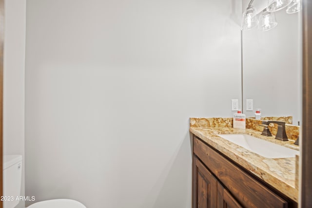 bathroom featuring toilet and vanity