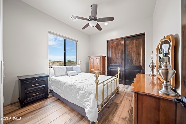 bedroom with ceiling fan and hardwood / wood-style flooring